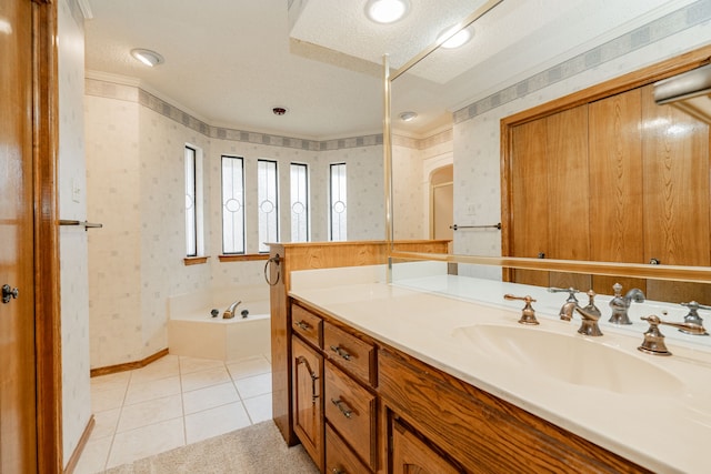 bathroom featuring crown molding, vanity, a bath, a textured ceiling, and tile patterned floors