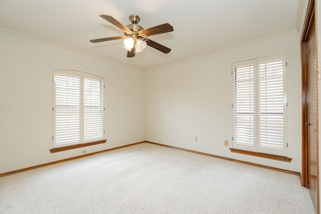 unfurnished room with ornamental molding, a healthy amount of sunlight, light colored carpet, and ceiling fan