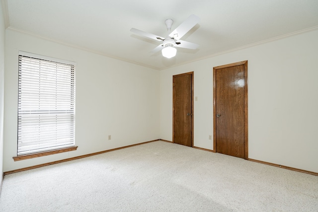 unfurnished bedroom with crown molding, carpet floors, and multiple windows