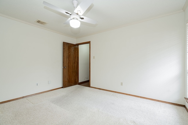 spare room featuring ornamental molding, carpet, and ceiling fan