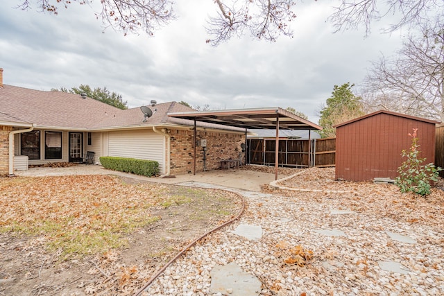 view of yard with a sunroom, a patio area, and a storage unit