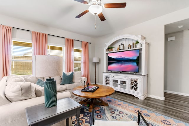 living room featuring ceiling fan, a wealth of natural light, and dark hardwood / wood-style flooring