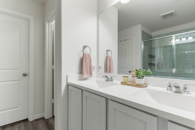 bathroom with vanity, wood-type flooring, and walk in shower