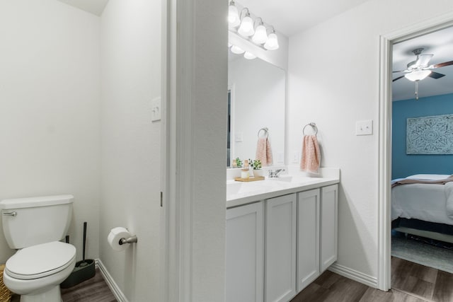 bathroom with ceiling fan, vanity, toilet, and hardwood / wood-style floors