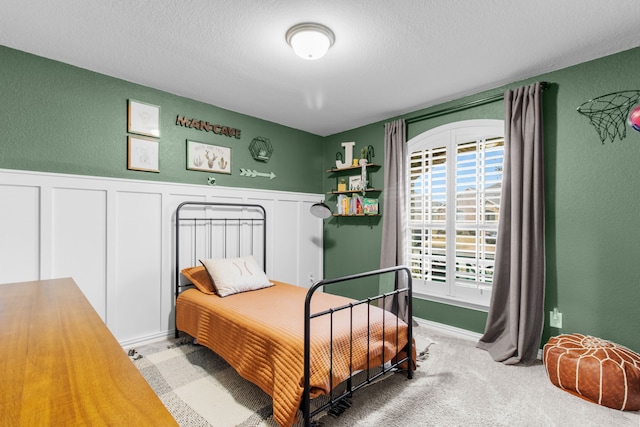 bedroom with carpet flooring and a textured ceiling