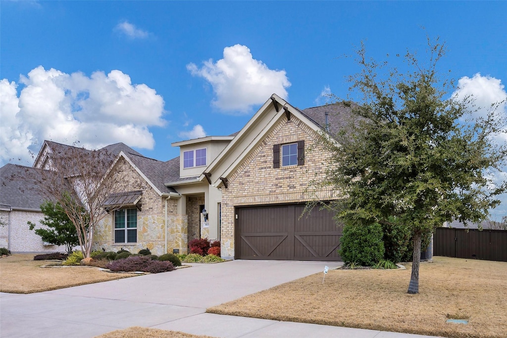 view of front facade with a garage and a front lawn