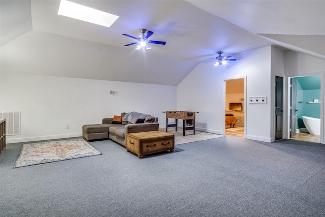 interior space featuring lofted ceiling with skylight and ceiling fan