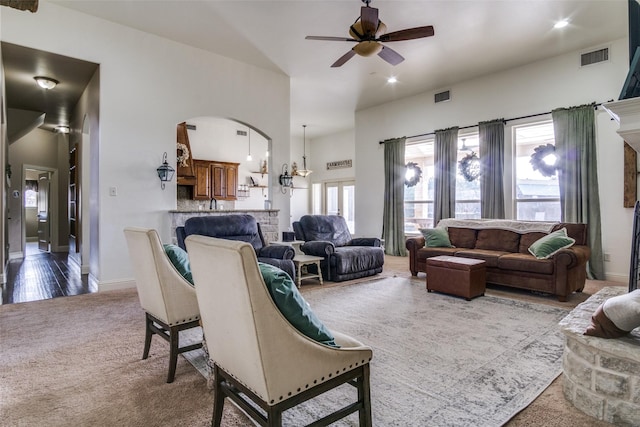 living room with ceiling fan and carpet flooring