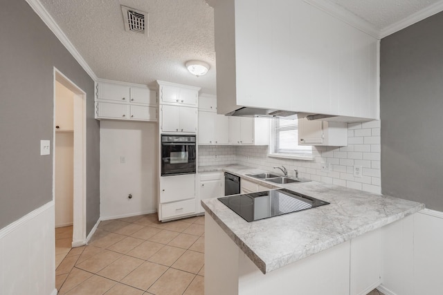 kitchen featuring sink, crown molding, white cabinetry, black appliances, and kitchen peninsula