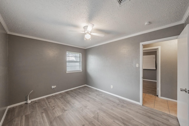 unfurnished bedroom featuring crown molding, ceiling fan, a textured ceiling, and light wood-type flooring