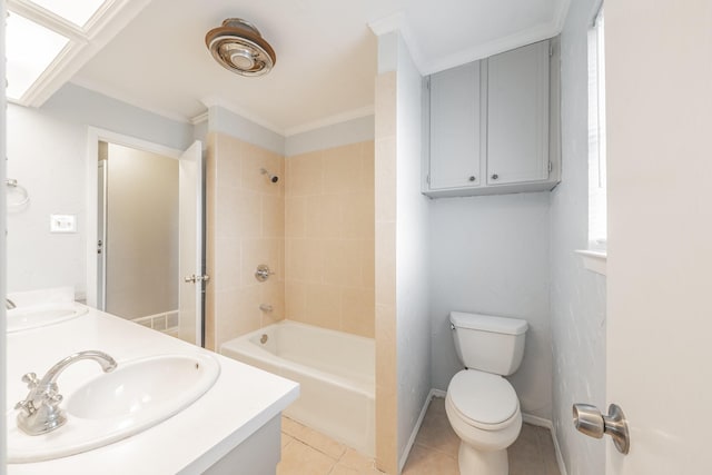 full bathroom featuring toilet, a skylight, vanity, tiled shower / bath combo, and tile patterned flooring