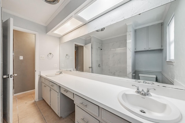 bathroom featuring toilet, a tile shower, ornamental molding, vanity, and tile patterned flooring