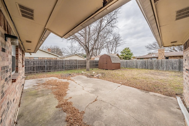 view of patio featuring a shed