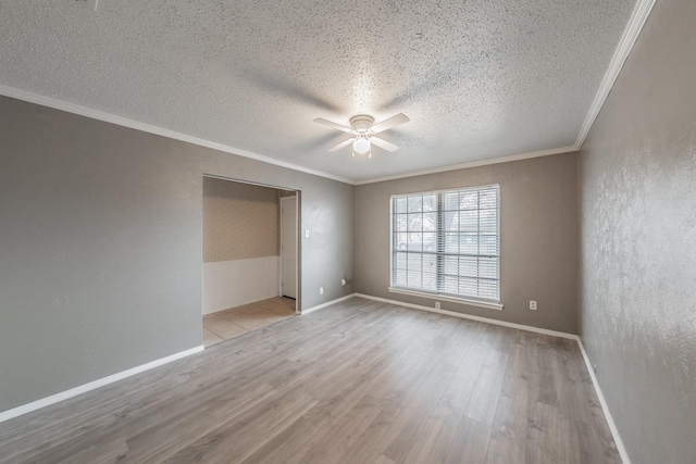 unfurnished room featuring crown molding, light hardwood / wood-style floors, ceiling fan, and a textured ceiling