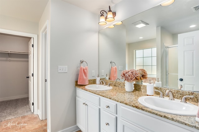 bathroom with vanity, tile patterned floors, and walk in shower