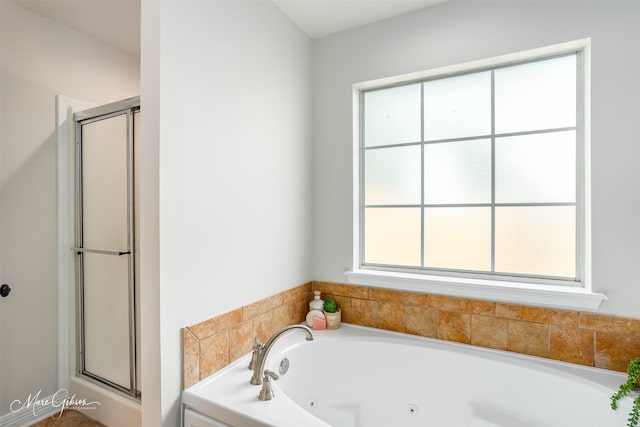 bathroom featuring shower with separate bathtub