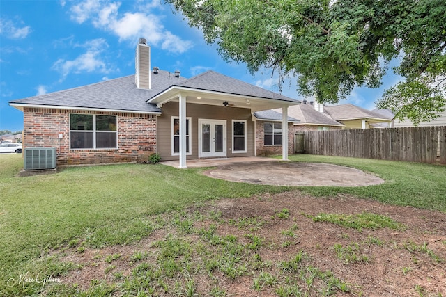 rear view of property featuring a yard, a patio area, central air condition unit, and french doors