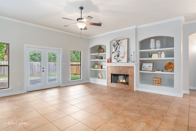 unfurnished living room with light tile patterned flooring, ornamental molding, and built in shelves