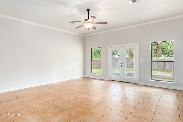 tiled spare room featuring ornamental molding, french doors, and ceiling fan