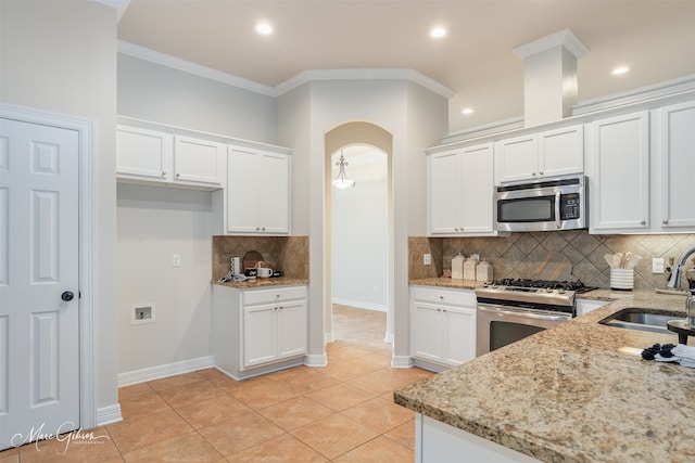 kitchen with white cabinetry, light stone countertops, and stainless steel appliances