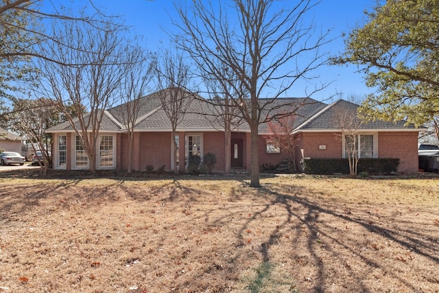 ranch-style home with a front lawn