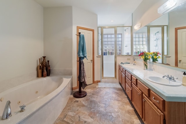 bathroom featuring shower with separate bathtub and vanity