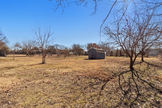 view of yard featuring a storage unit and a rural view