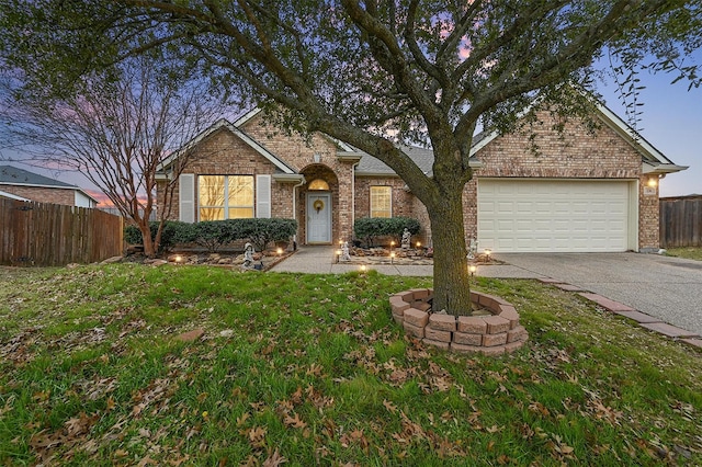 view of front of property with a garage and a lawn