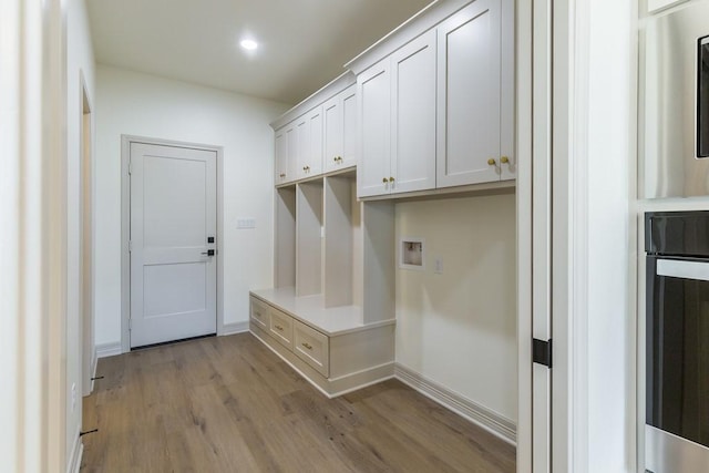 mudroom with light hardwood / wood-style floors