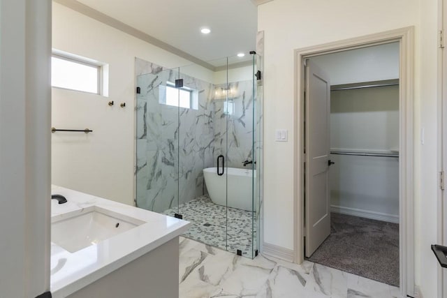 bathroom with vanity and shower with separate bathtub