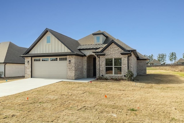 view of front of home with a garage and a front yard