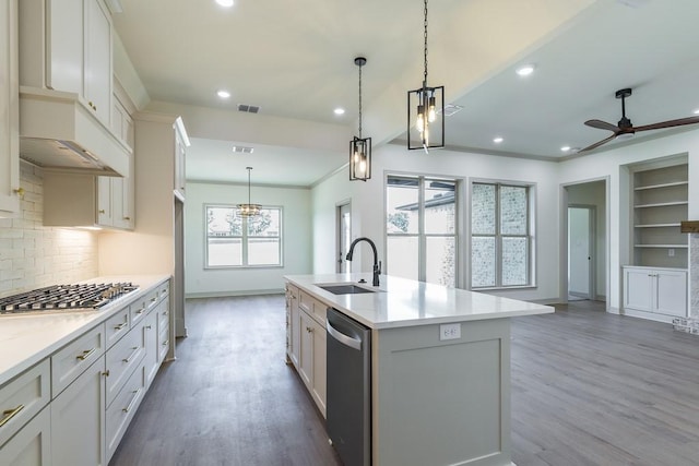 kitchen with a kitchen island with sink, sink, stainless steel appliances, and white cabinets