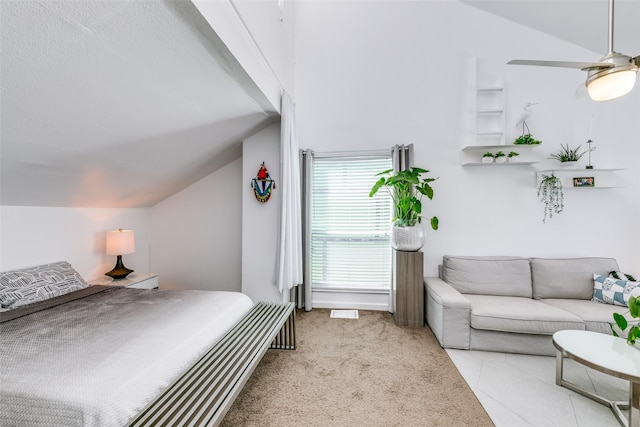 carpeted bedroom with lofted ceiling