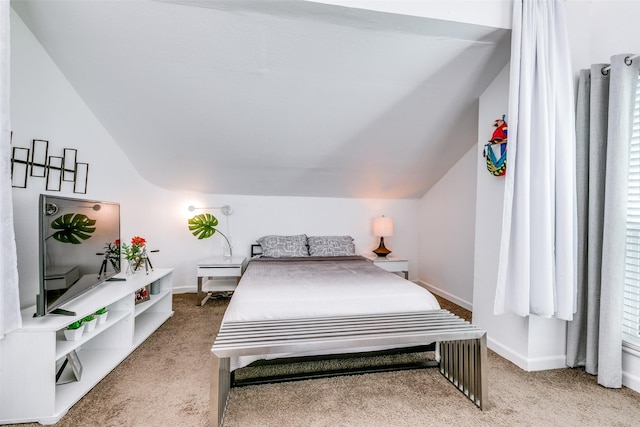 bedroom with lofted ceiling and carpet floors