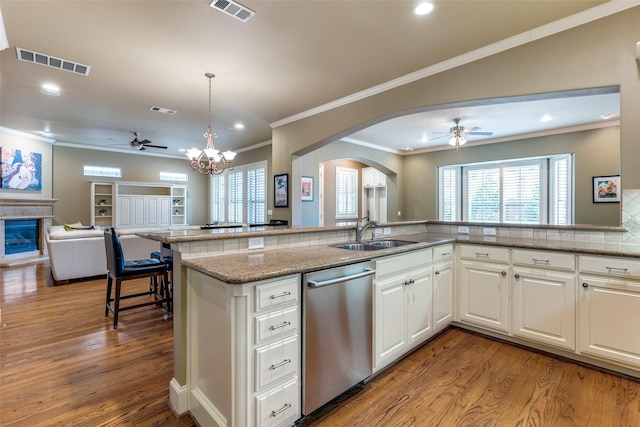 kitchen featuring sink, stainless steel dishwasher, white cabinets, and light hardwood / wood-style floors