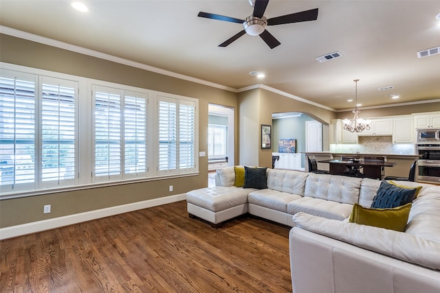 living room with ceiling fan with notable chandelier, ornamental molding, and hardwood / wood-style floors