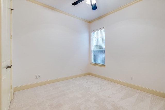 carpeted spare room with crown molding and ceiling fan