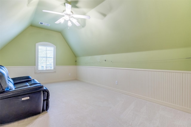 additional living space featuring vaulted ceiling, light carpet, and ceiling fan