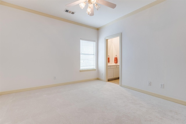 carpeted spare room featuring crown molding and ceiling fan