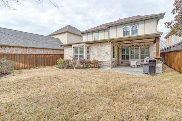 back of property with a yard, a patio, and ceiling fan