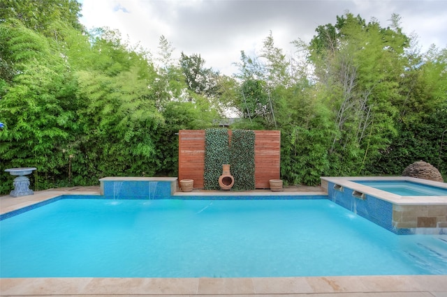 view of swimming pool featuring an in ground hot tub and pool water feature