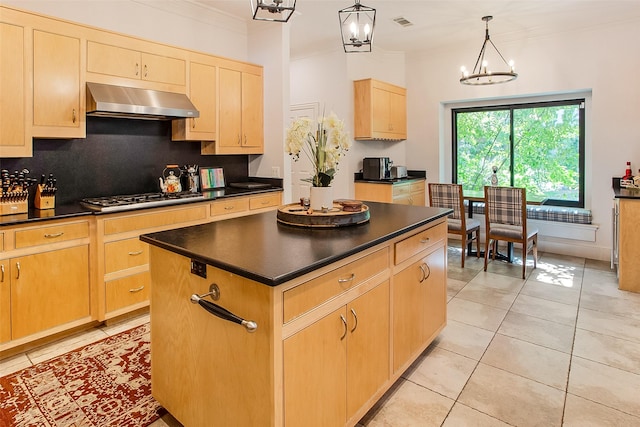 kitchen featuring decorative light fixtures, a chandelier, ventilation hood, a kitchen island, and stainless steel gas stovetop