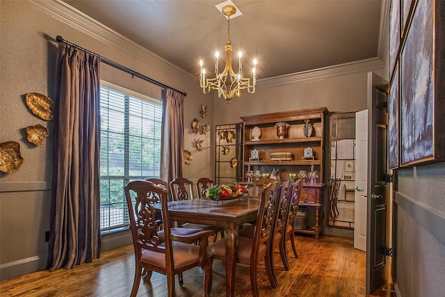 dining area featuring crown molding, a chandelier, and hardwood / wood-style flooring