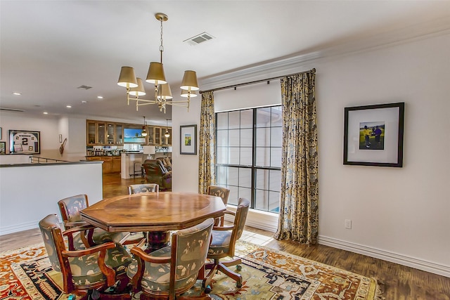 dining room featuring dark hardwood / wood-style floors and a notable chandelier