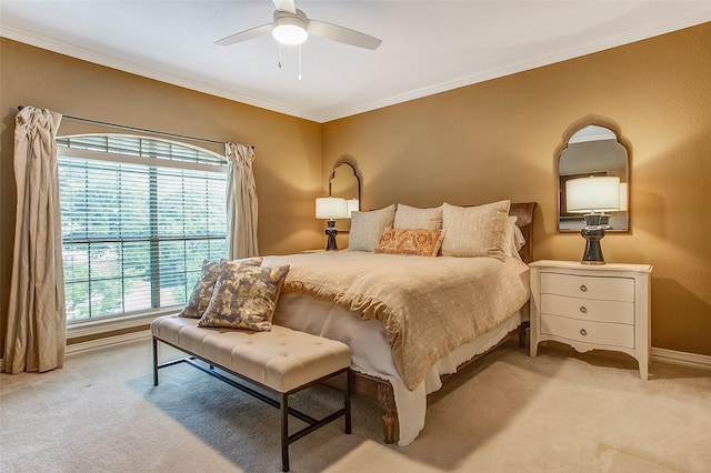 bedroom featuring crown molding, light colored carpet, and ceiling fan