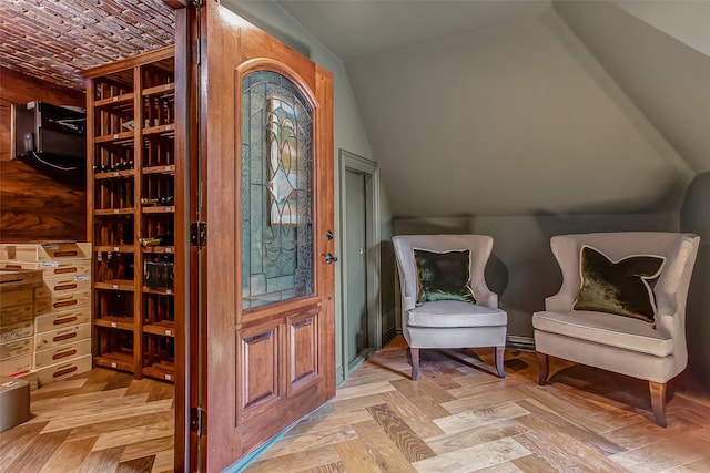 interior space with vaulted ceiling and light parquet floors