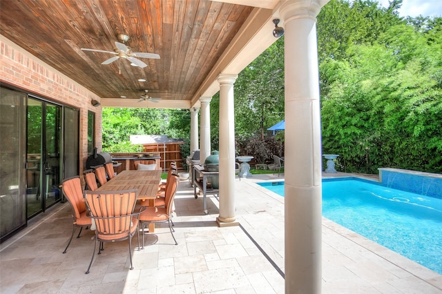 view of swimming pool with ceiling fan and a patio