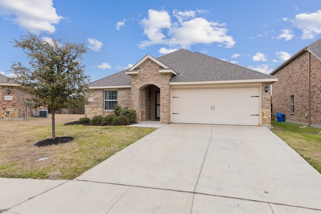 ranch-style house with an attached garage, brick siding, a shingled roof, concrete driveway, and a front yard