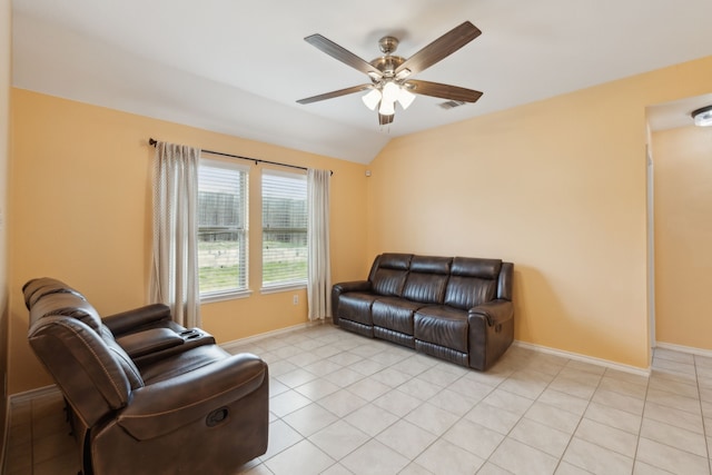 living room featuring ceiling fan, vaulted ceiling, and light tile patterned floors