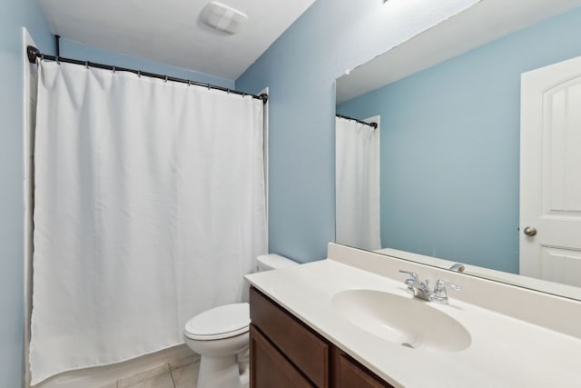 bathroom featuring vanity, tile patterned floors, and toilet